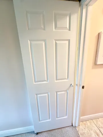 a view of a swimming pool with a lawn chairs under an umbrella next to a yard