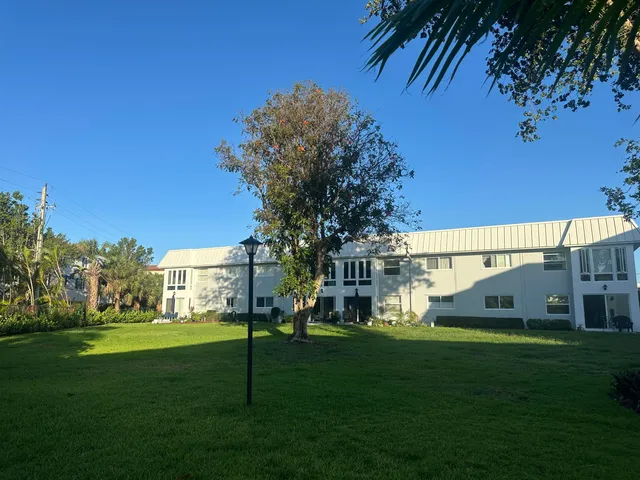 a kitchen with granite countertop a stove a sink and a microwave