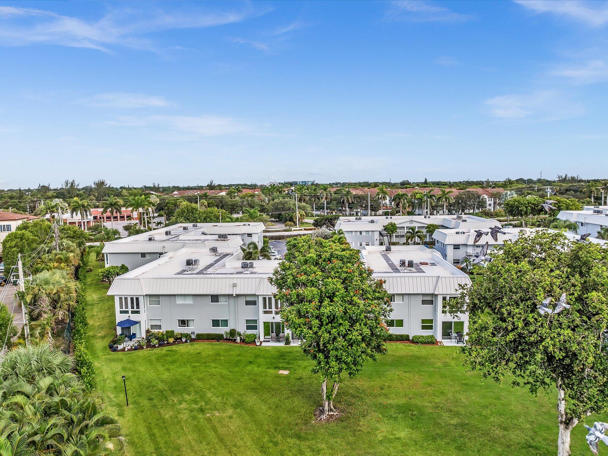 33 Colonial Club Drive, Unit 203 Boynton Beach, FL 33435 - Photo 52 of 61 an aerial view of residential houses with outdoor space and trees