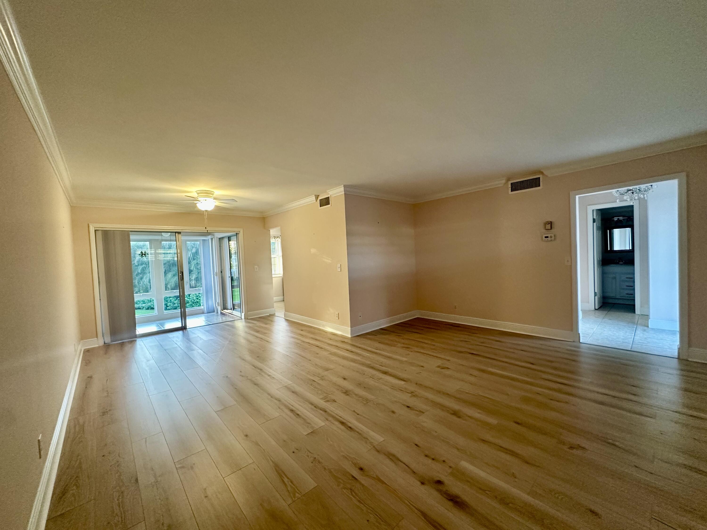 33 Colonial Club Drive, Unit 203 Boynton Beach, FL 33435 - Photo 8 of 61 a view of empty room with wooden floor and fan