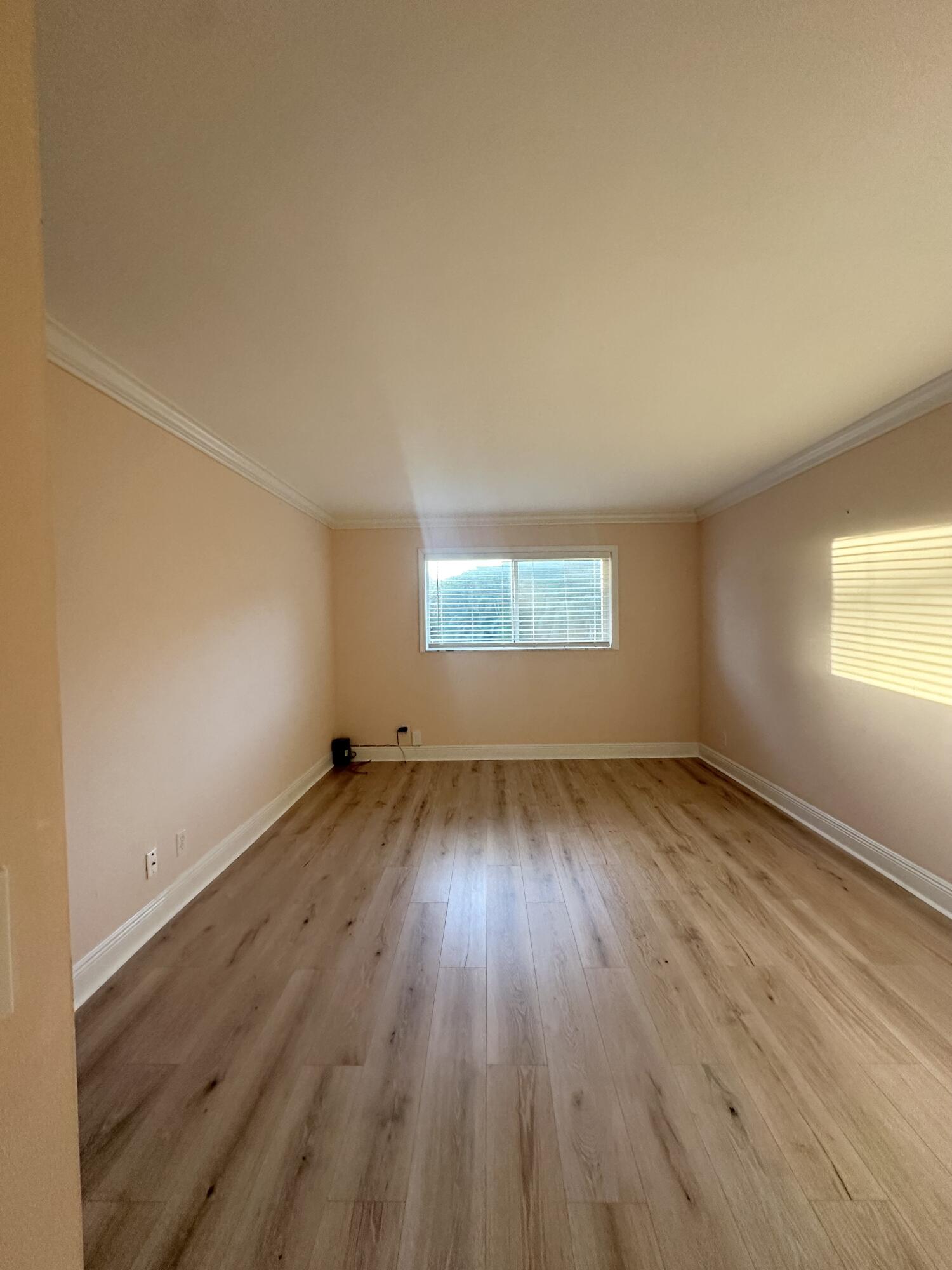 33 Colonial Club Drive, Unit 203 Boynton Beach, FL 33435 - Photo 9 of 61 an empty room with wooden floor and windows