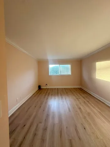 a view of kitchen with granite countertop cabinets and a large window