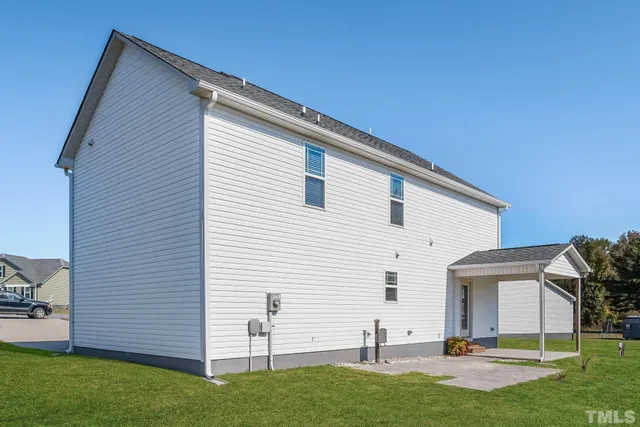 a view of backyard of house with outdoor seating