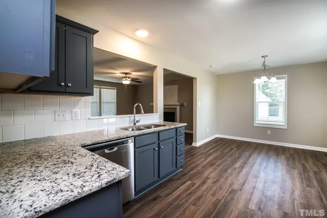 a kitchen with a sink stove and refrigerator