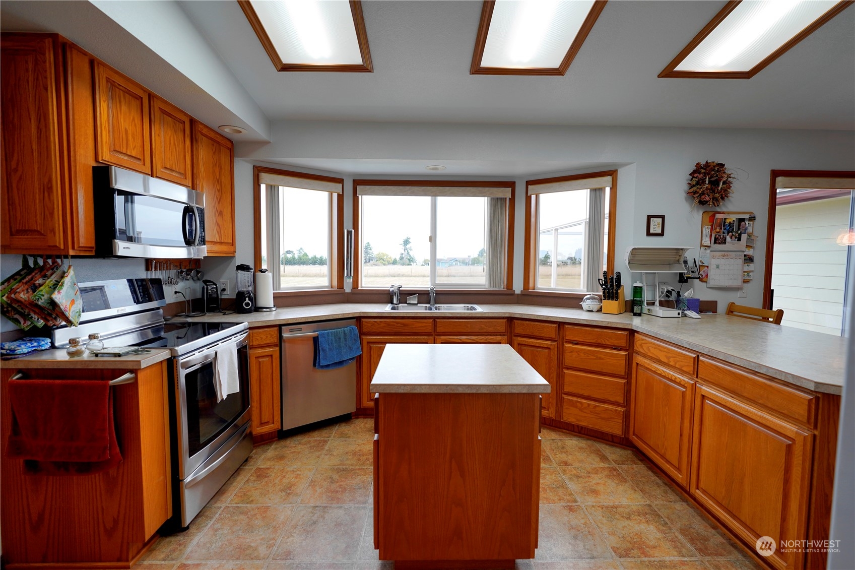 123 East Anderson Road Sequim, WA 98382 - Photo 12 of 40 a kitchen with stainless steel appliances granite countertop sink stove top oven and cabinets