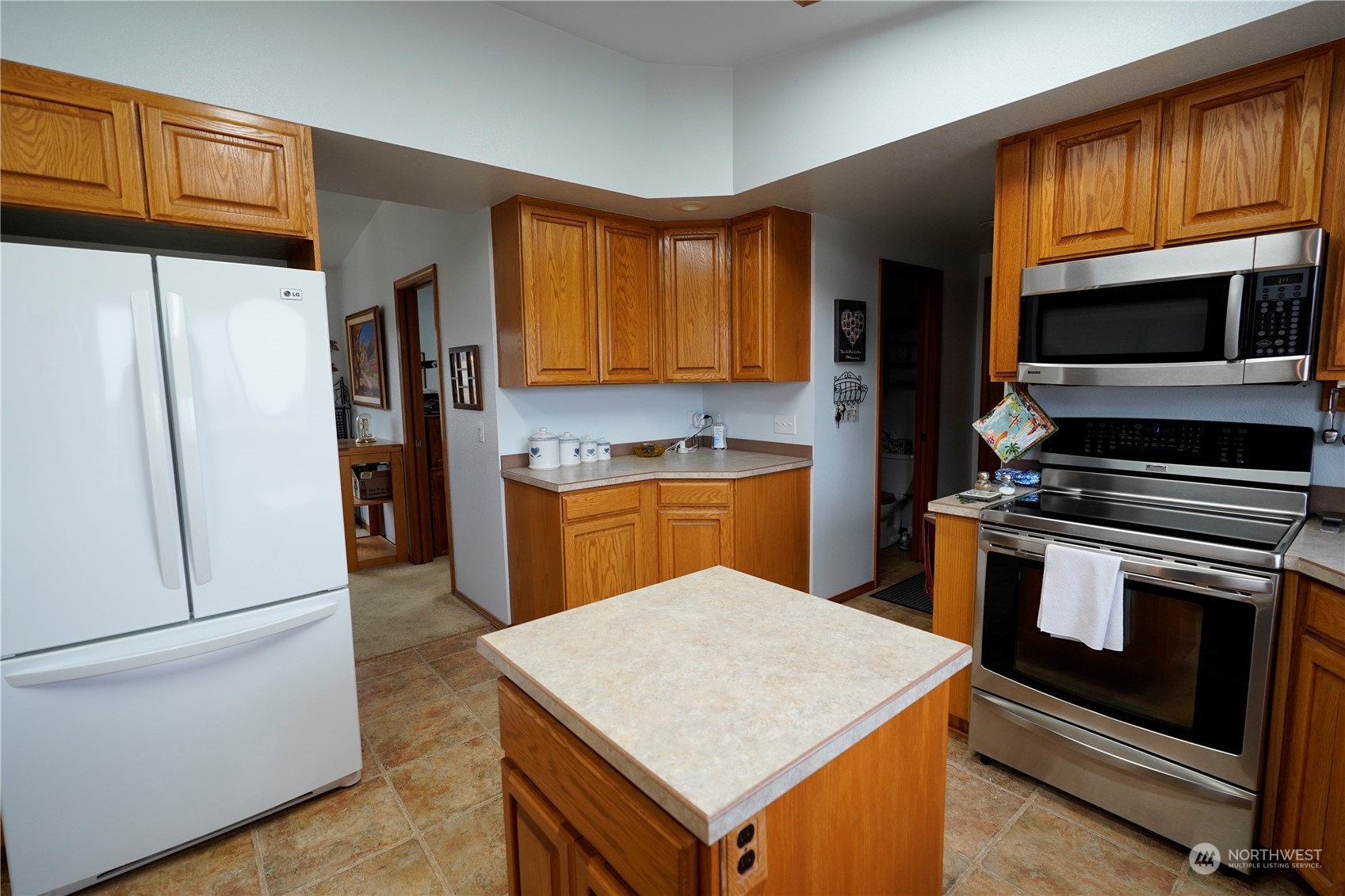 123 East Anderson Road Sequim, WA 98382 - Photo 13 of 40 a kitchen with stainless steel appliances granite countertop a refrigerator stove top oven a sink and dishwasher