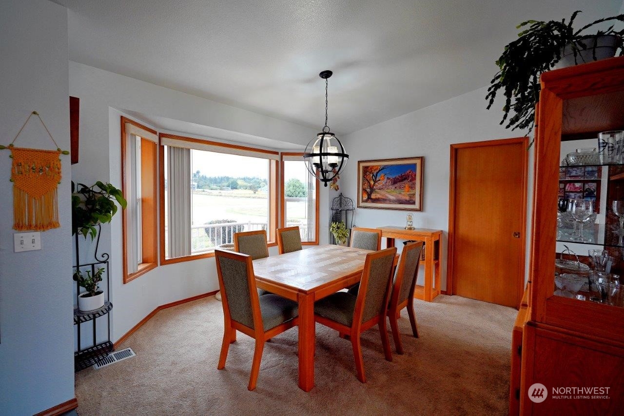 123 East Anderson Road Sequim, WA 98382 - Photo 16 of 40 a dining room with furniture window and wooden floor