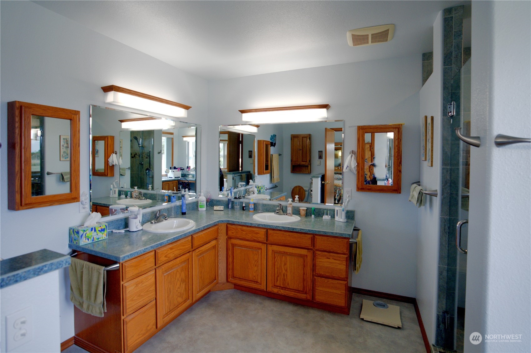123 East Anderson Road Sequim, WA 98382 - Photo 25 of 40 a spacious bathroom with a granite countertop sink and a mirror