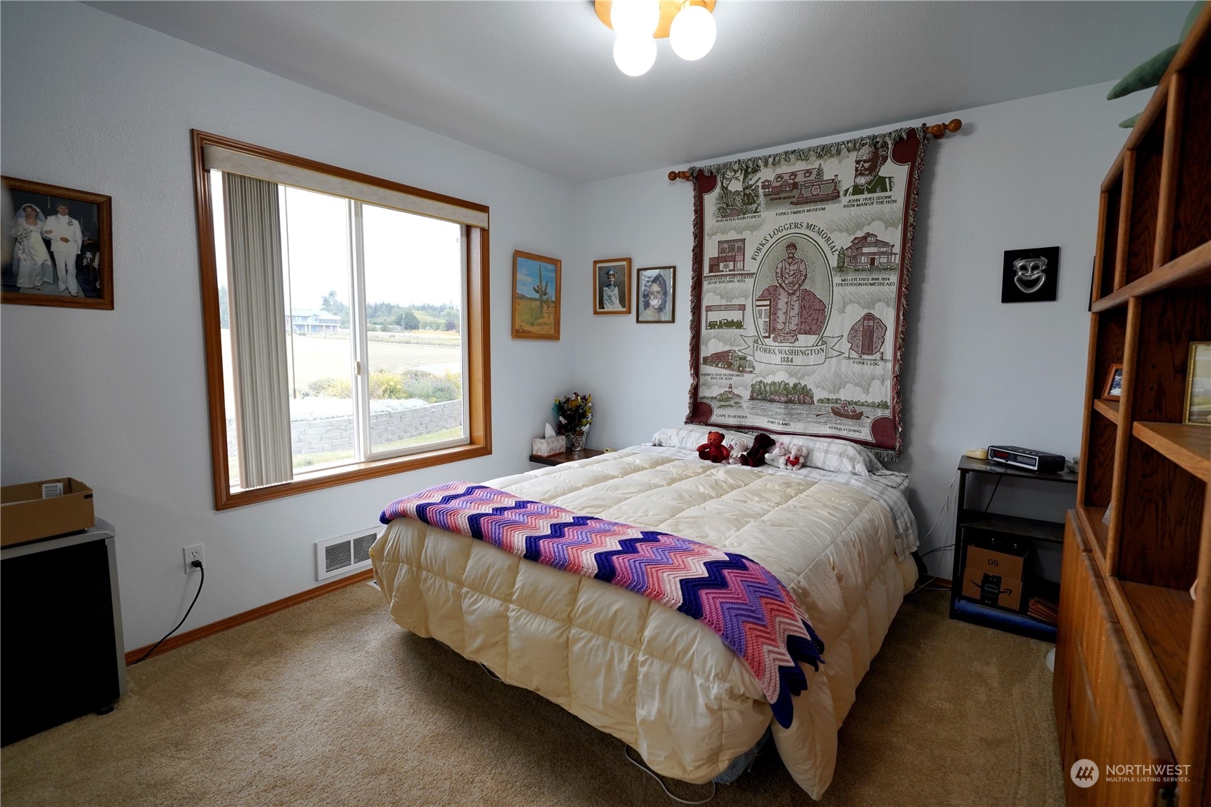 123 East Anderson Road Sequim, WA 98382 - Photo 26 of 40 a bedroom with a bed a dresser and a window