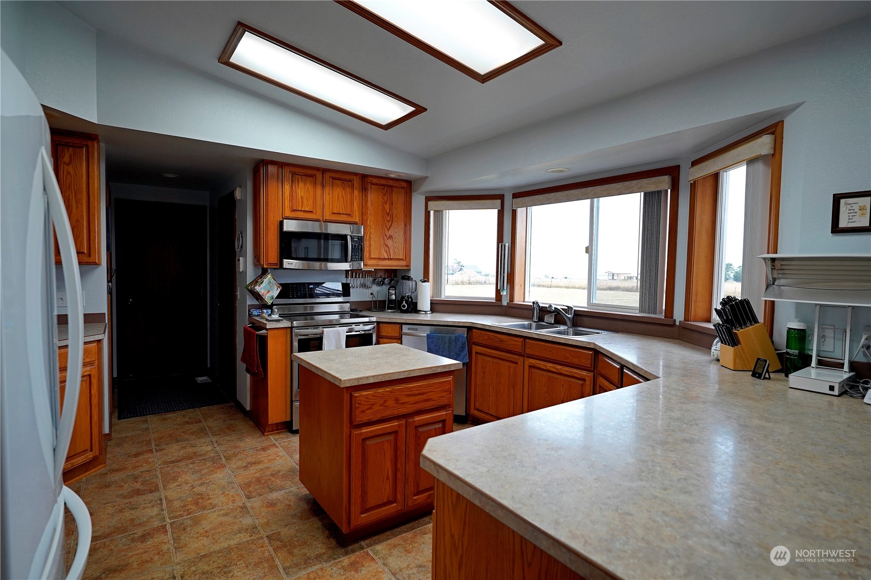 123 East Anderson Road Sequim, WA 98382 - Photo 9 of 40 a kitchen with stainless steel appliances granite countertop a sink a stove and a refrigerator