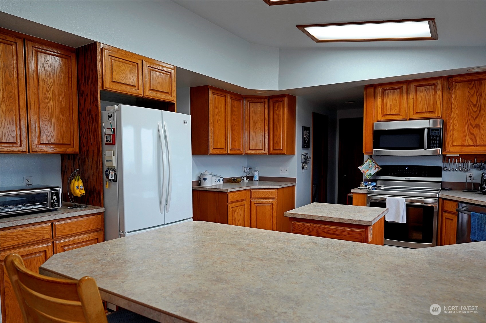 123 East Anderson Road Sequim, WA 98382 - Photo 10 of 40 a kitchen with stainless steel appliances a refrigerator stove top oven and sink