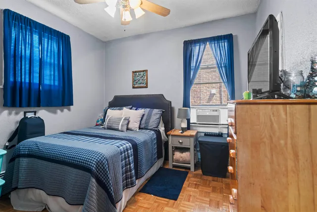 a bedroom with a bed and a window