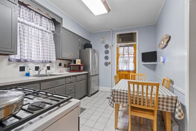 a kitchen with a stove a sink and a refrigerator