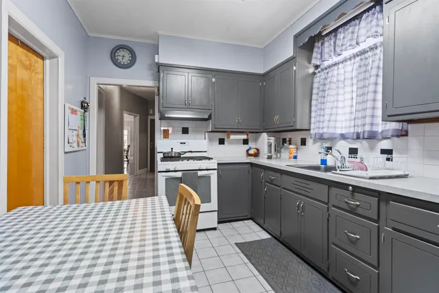 a kitchen with granite countertop cabinets a sink a window and stainless steel appliances