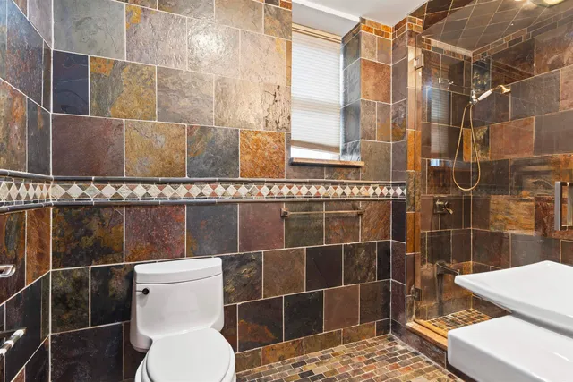 a bathroom with a toilet and a shower