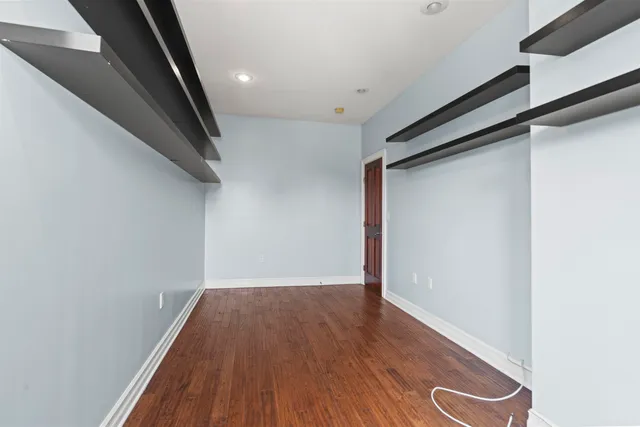 a view of a hallway with wooden floor