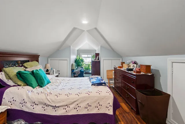 a bed room with a bed and a chair