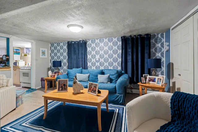 a living room with furniture a lamp and a large window