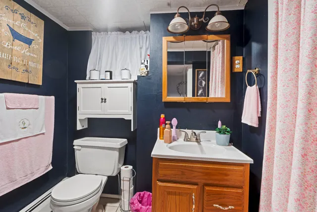 a bathroom with a toilet a sink and a mirror