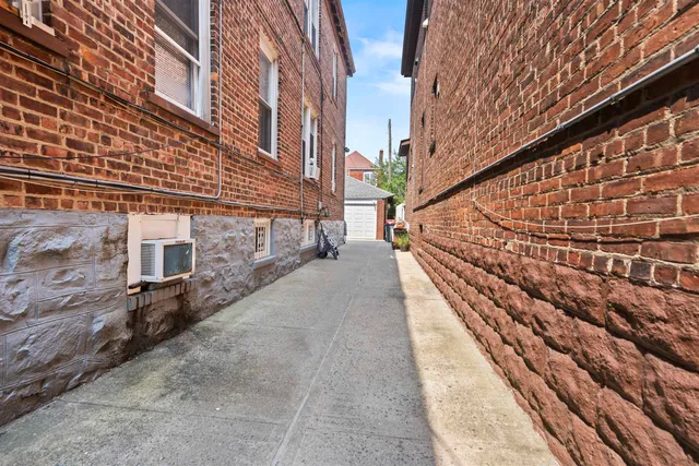 a view of a brick house with many windows