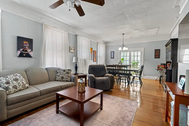a living room with furniture and wooden floor