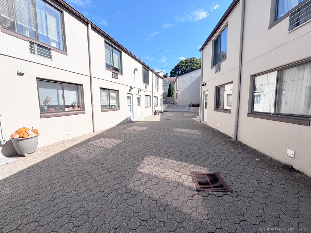 84 Taylor Avenue, Unit 1 Norwalk, CT 06854 - Photo 1 of 21 a view of a street with buildings