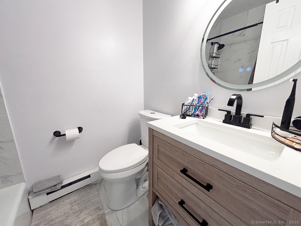 84 Taylor Avenue, Unit 1 Norwalk, CT 06854 - Photo 15 of 21 a bathroom with a sink mirror and toilet