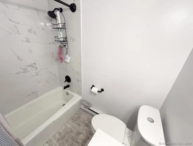 a bathroom with a bathtub and toilet
