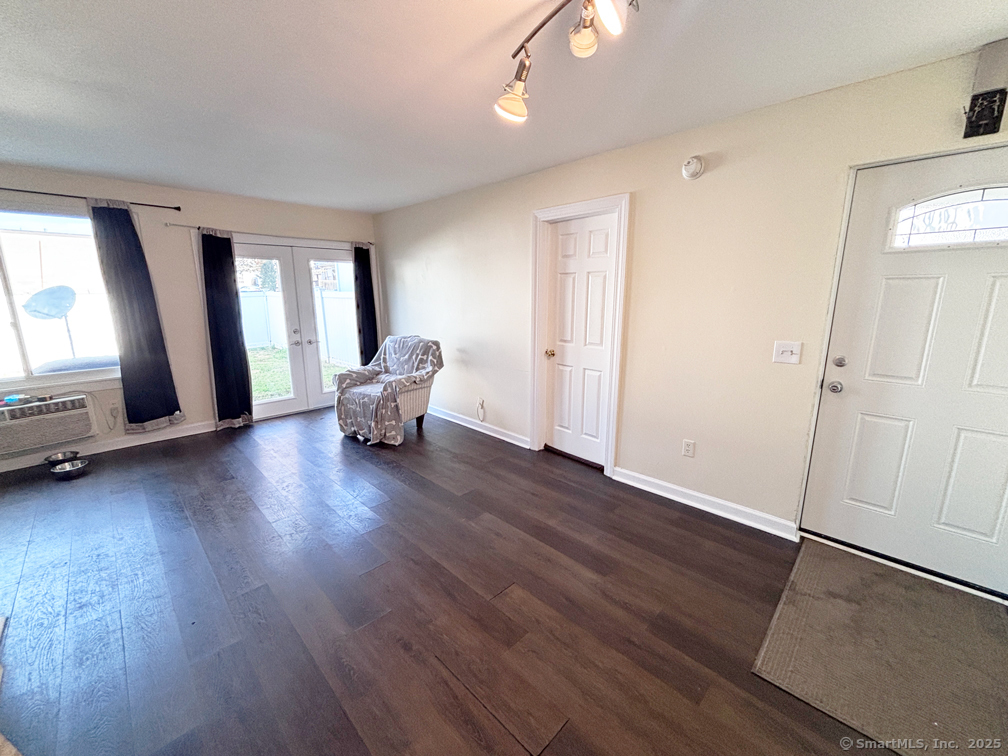 84 Taylor Avenue, Unit 1 Norwalk, CT 06854 - Photo 5 of 21 an empty room with wooden floor and windows