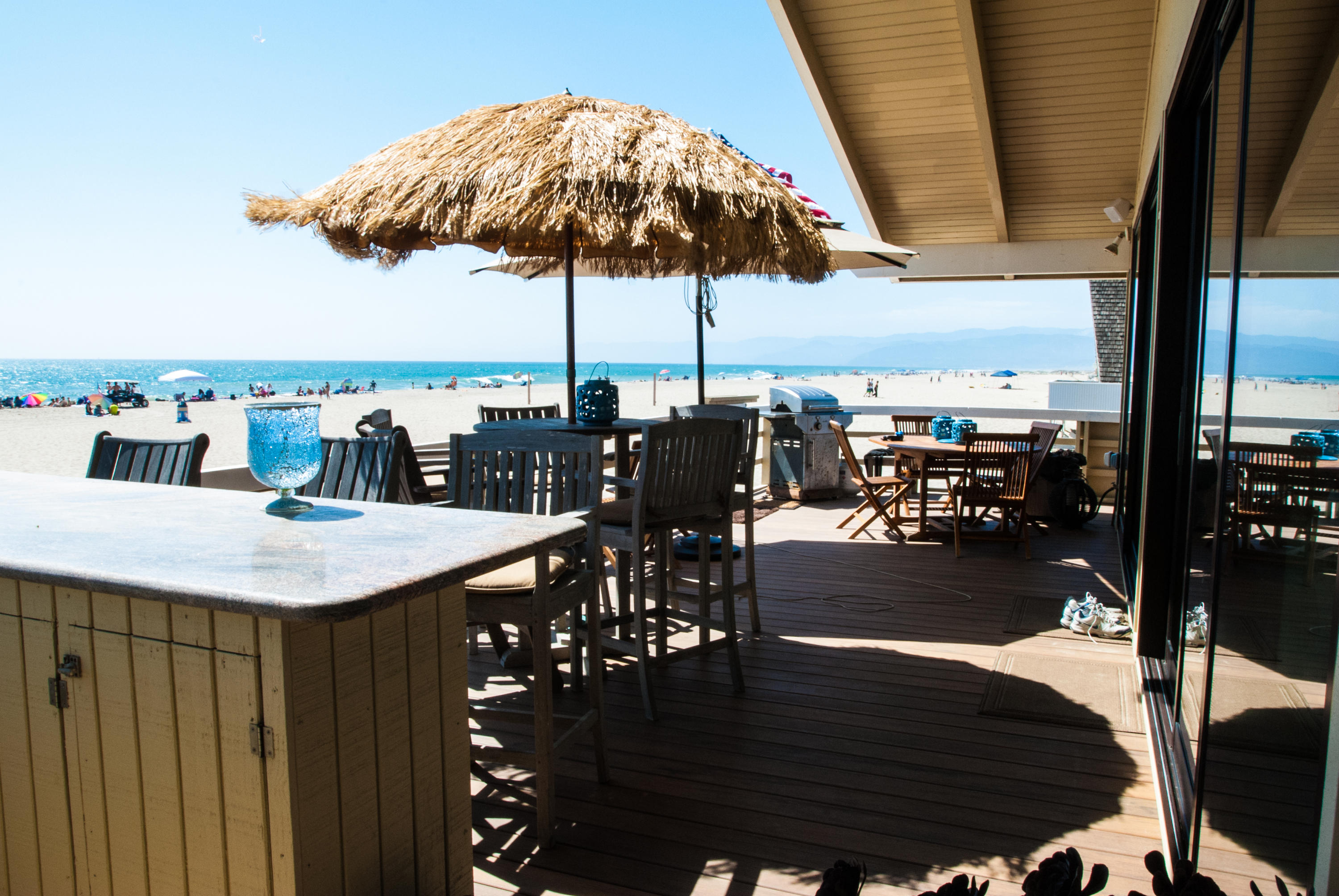 867 Mandalay Beach Road Oxnard, CA 93035 - Photo 11 of 27 a roof deck with dining table and chairs