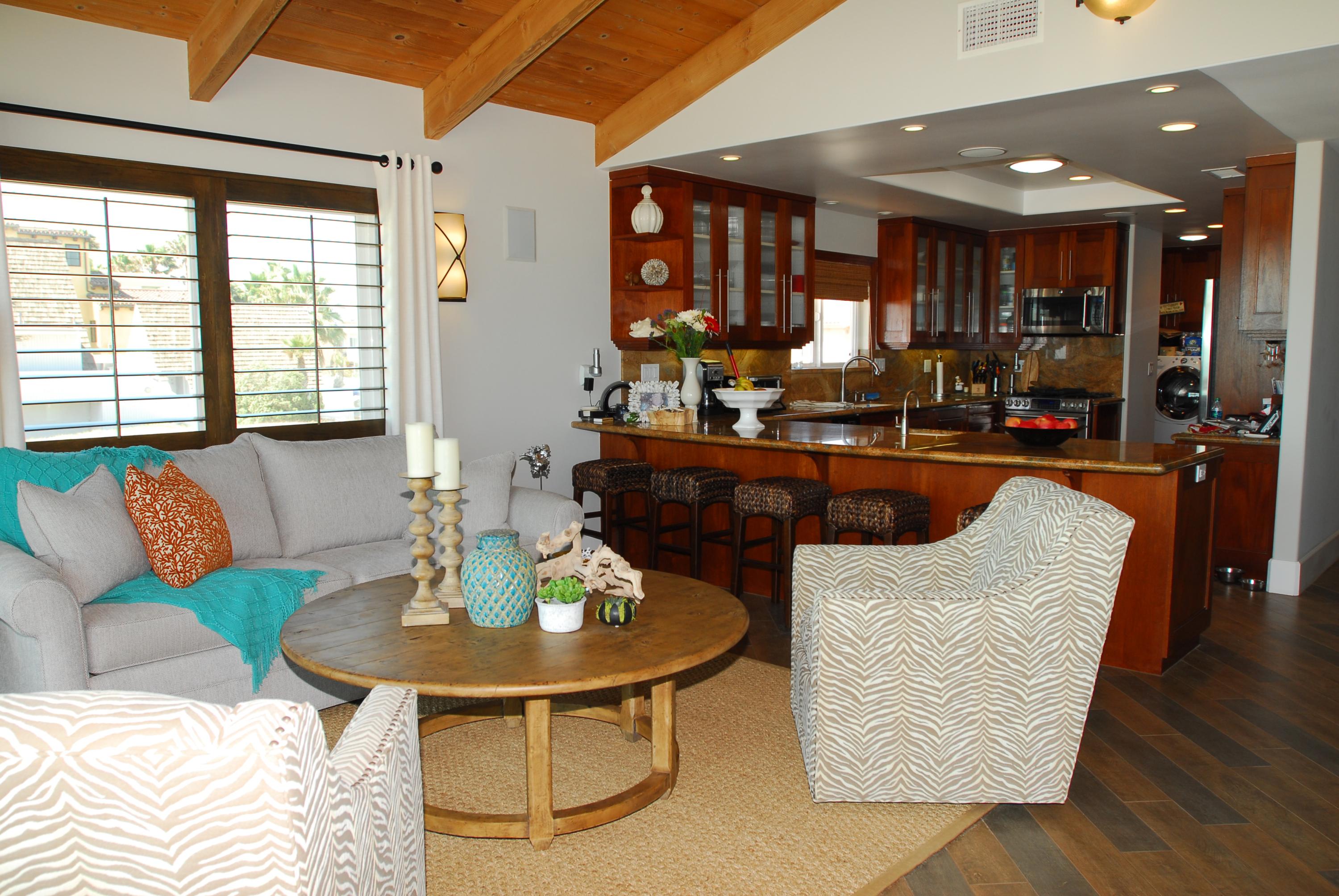 867 Mandalay Beach Road Oxnard, CA 93035 - Photo 15 of 27 a dining room with furniture a rug and kitchen view