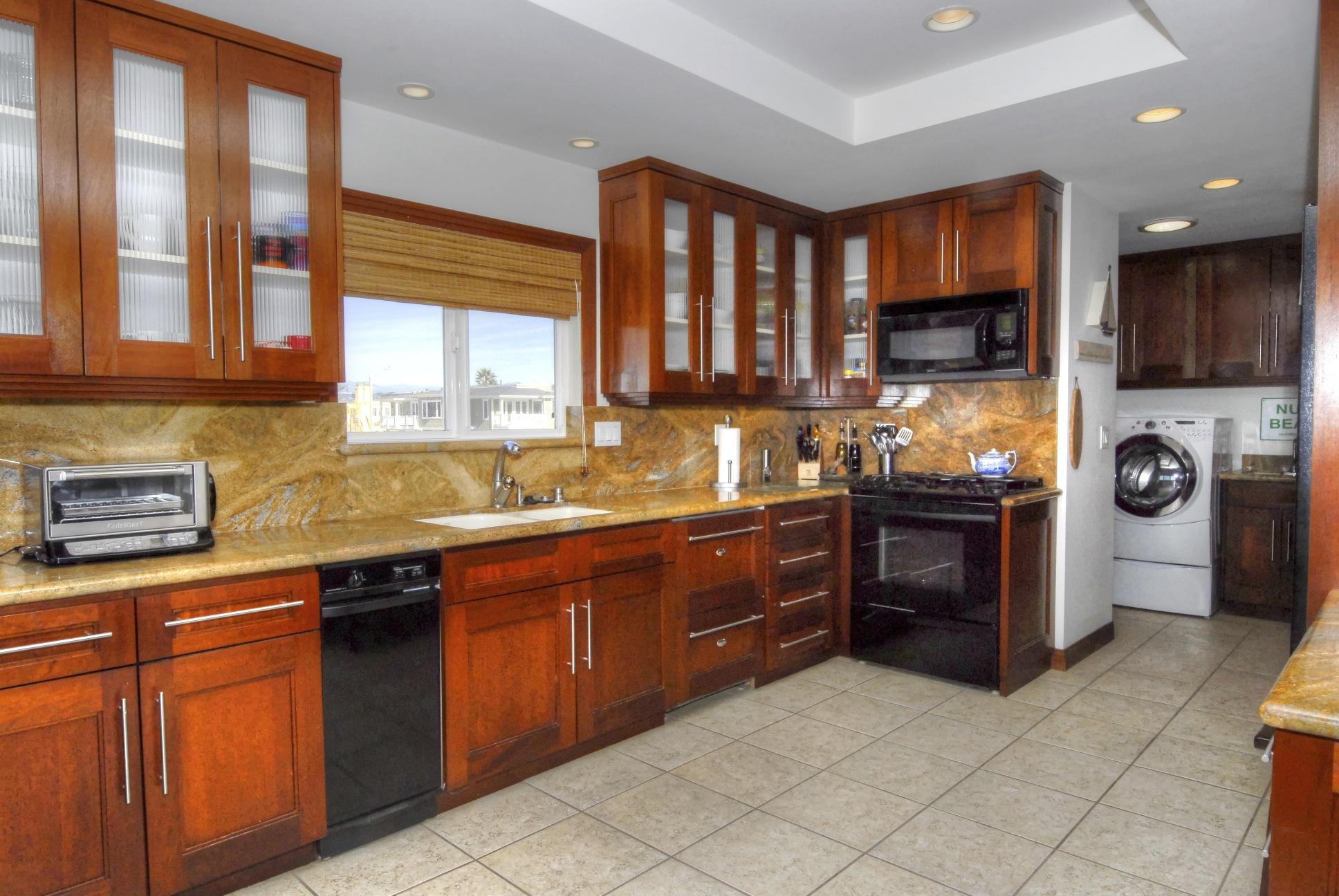 867 Mandalay Beach Road Oxnard, CA 93035 - Photo 3 of 27 a kitchen with stainless steel appliances granite countertop a stove sink and cabinets