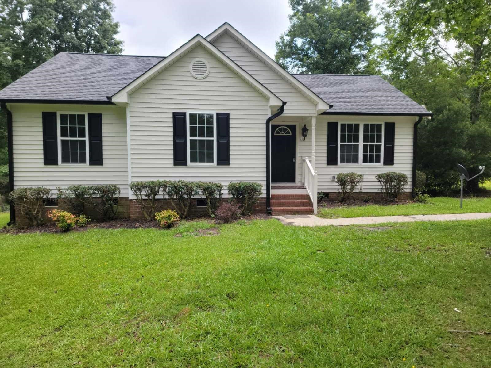 a front view of a house with yard