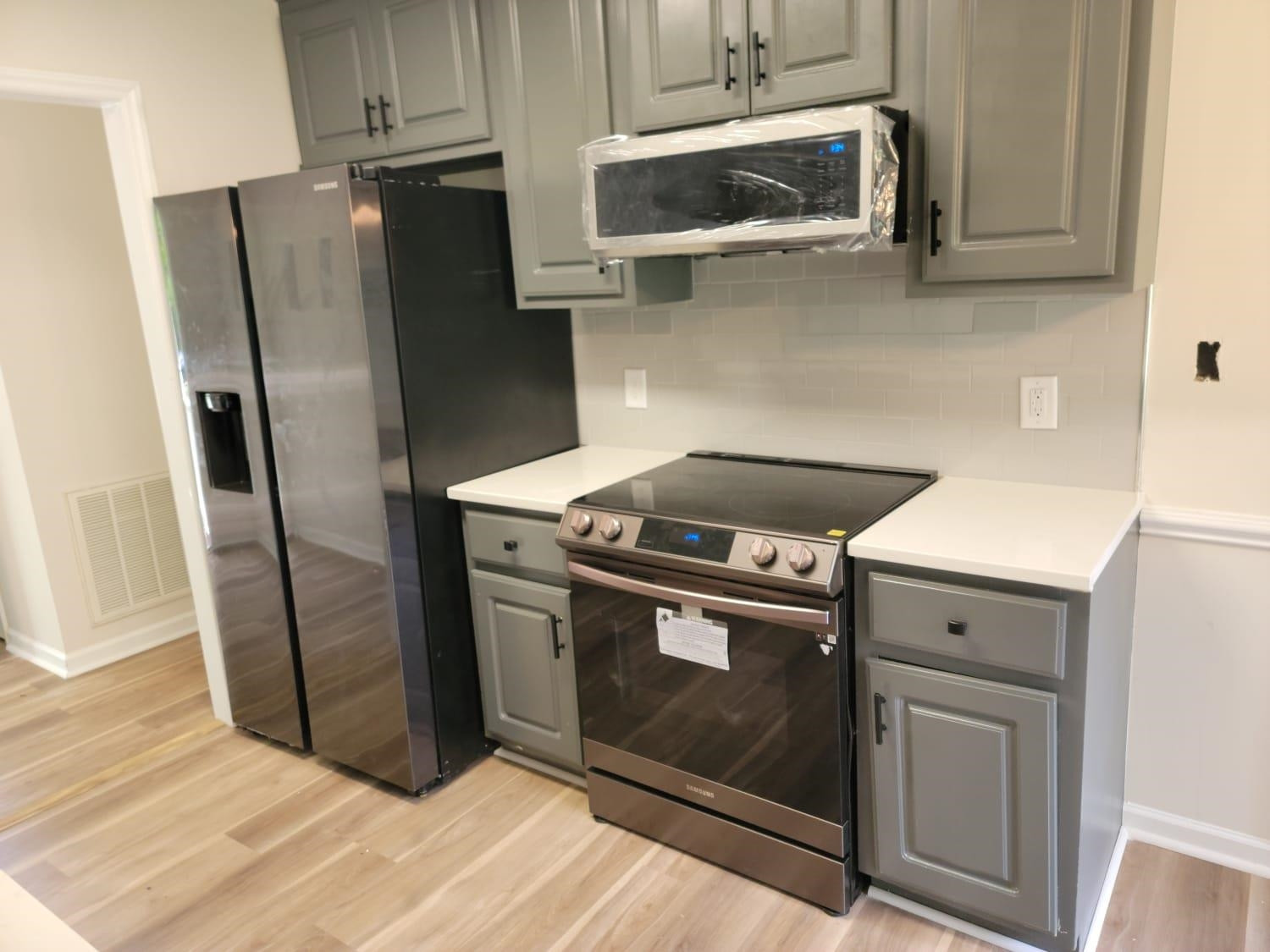 112 Pebblestone Court Willow Spring, NC 27592 - Photo 12 of 43 a kitchen with stainless steel appliances wooden floor sink and wooden cabinets