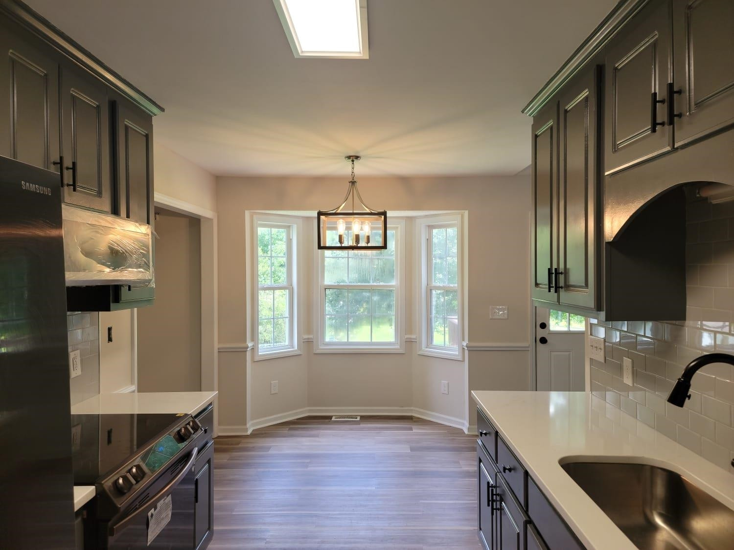 112 Pebblestone Court Willow Spring, NC 27592 - Photo 17 of 43 a kitchen with stainless steel appliances granite countertop a sink a stove and a wooden floors