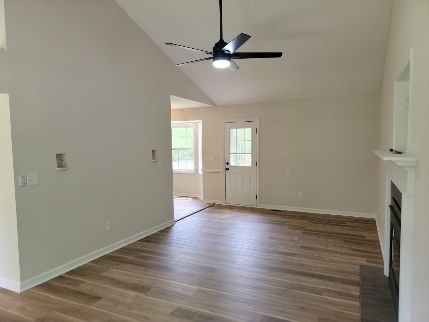112 Pebblestone Court Willow Spring, NC 27592 - Photo 19 of 43 a view of an empty room with a window and wooden floor