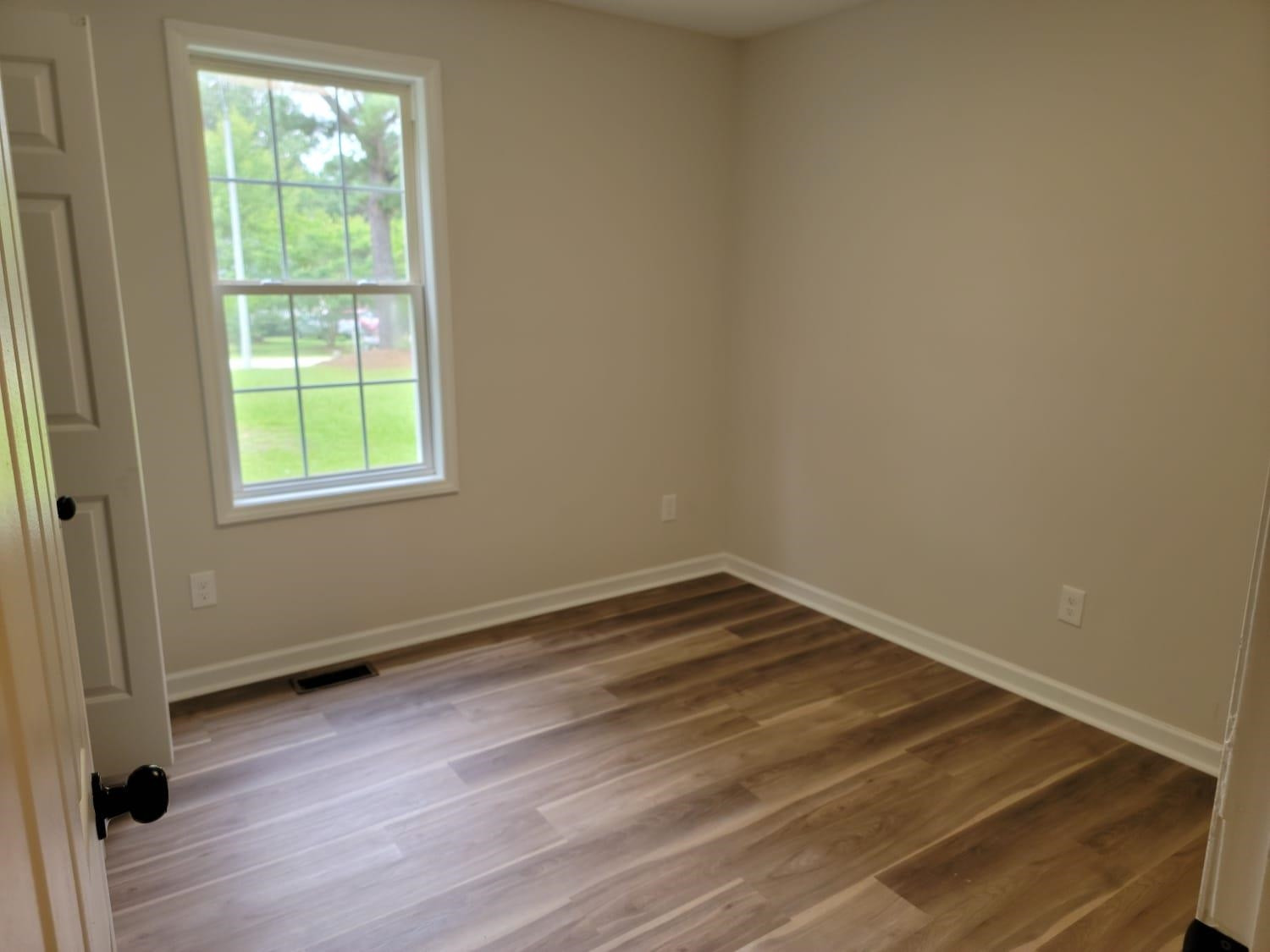 112 Pebblestone Court Willow Spring, NC 27592 - Photo 24 of 43 an empty room with wooden floor and windows