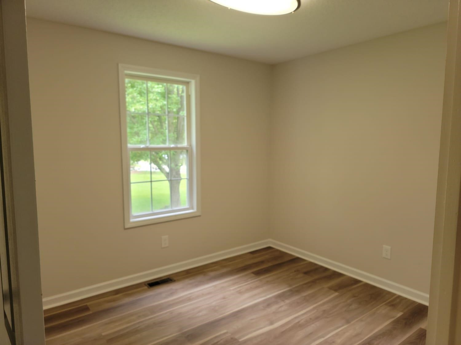 112 Pebblestone Court Willow Spring, NC 27592 - Photo 27 of 43 an empty room with wooden floor and windows