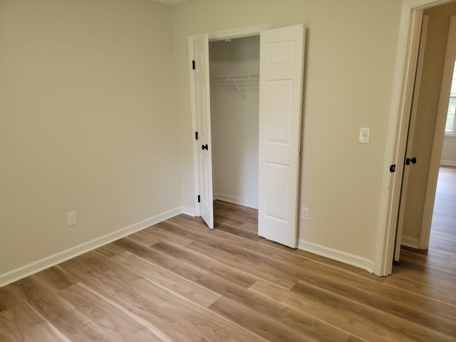 112 Pebblestone Court Willow Spring, NC 27592 - Photo 30 of 43 an empty room with wooden floor and entrance