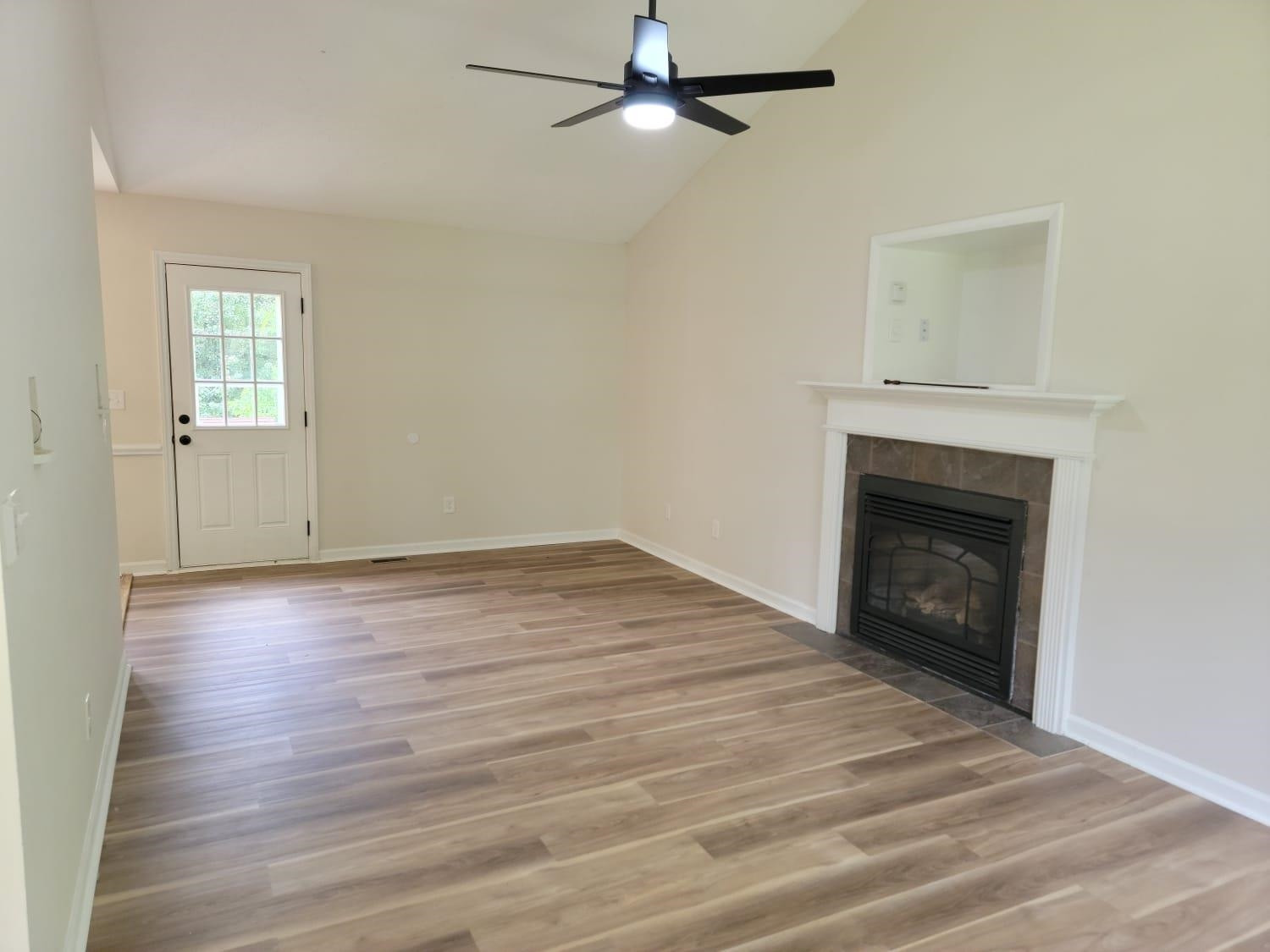 112 Pebblestone Court Willow Spring, NC 27592 - Photo 7 of 43 a view of empty room with wooden floor and fireplace