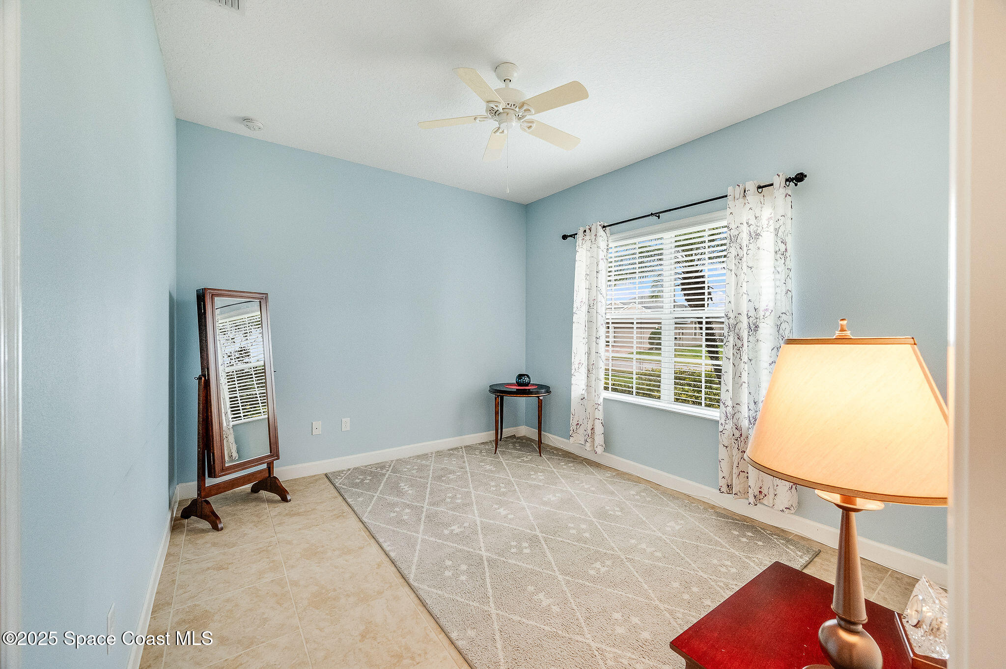 6531 Ingalls Street Melbourne, FL 32940 - Photo 13 of 46 an empty room with windows and ceiling fan