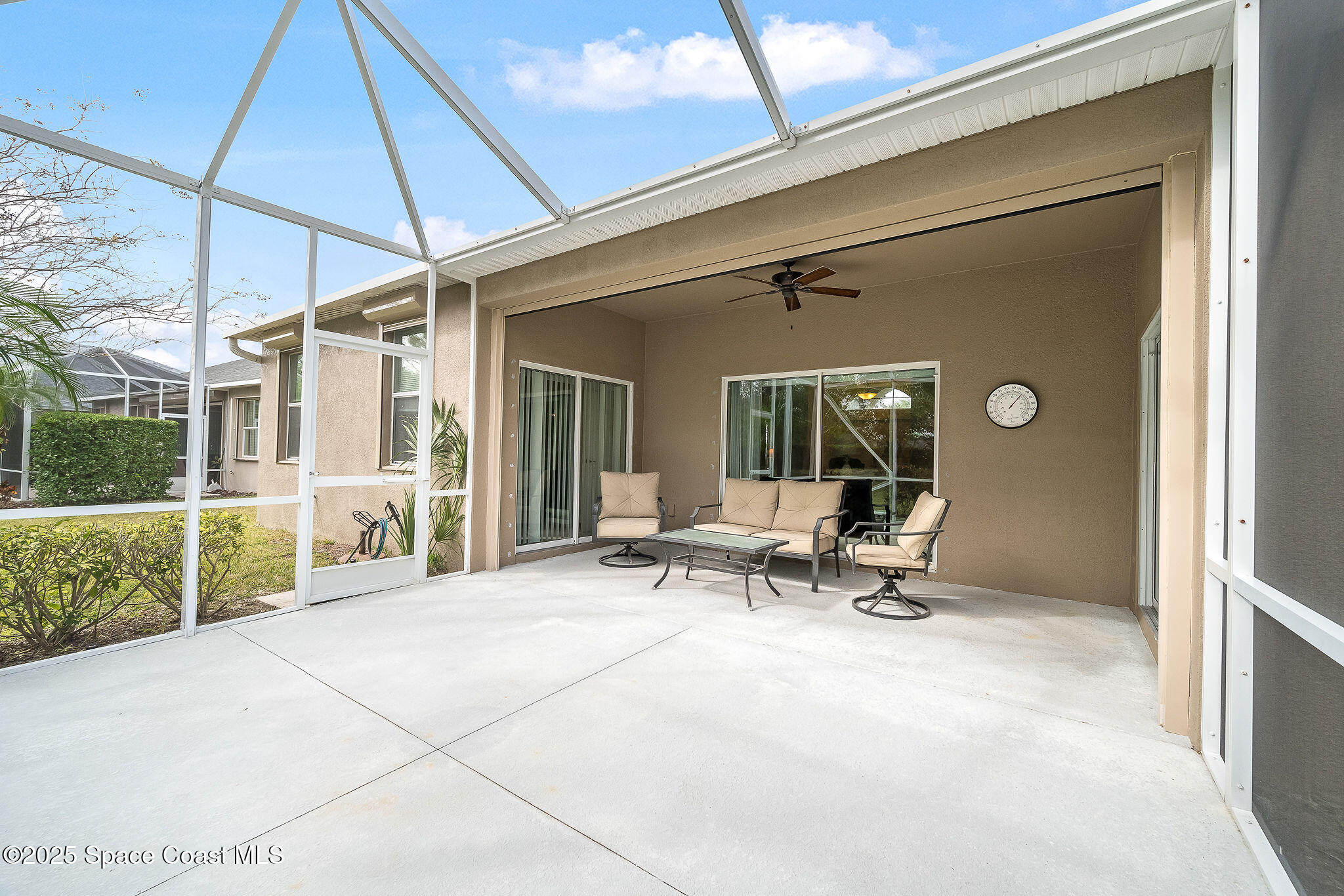 6531 Ingalls Street Melbourne, FL 32940 - Photo 27 of 46 a view of a patio with table and chairs under an umbrella