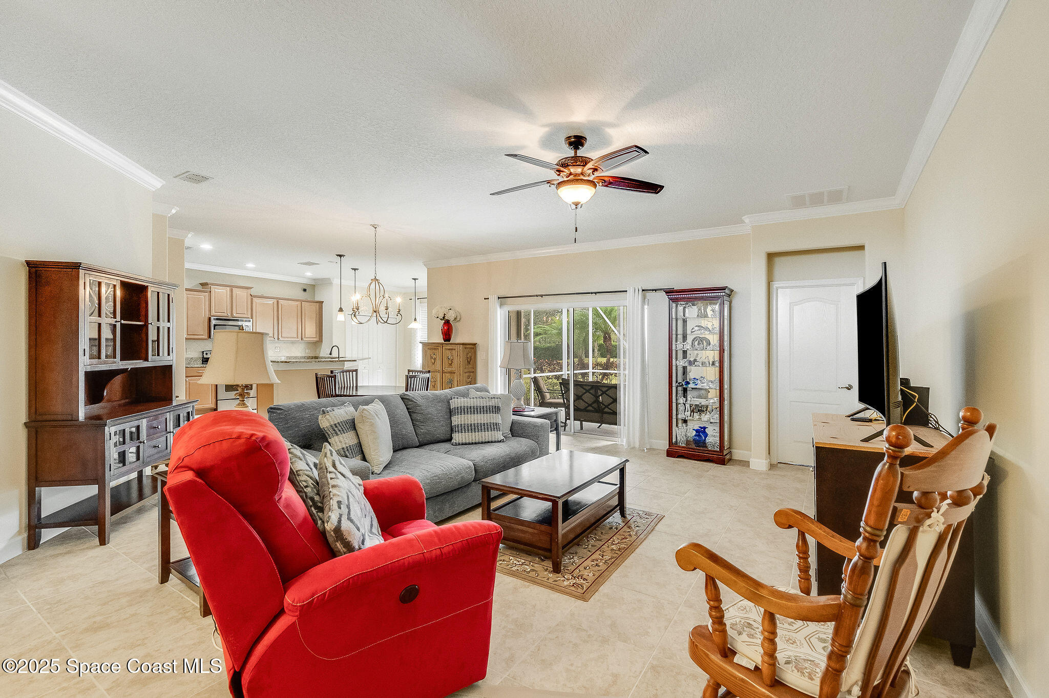 6531 Ingalls Street Melbourne, FL 32940 - Photo 30 of 46 a living room with furniture a ceiling fan and a window