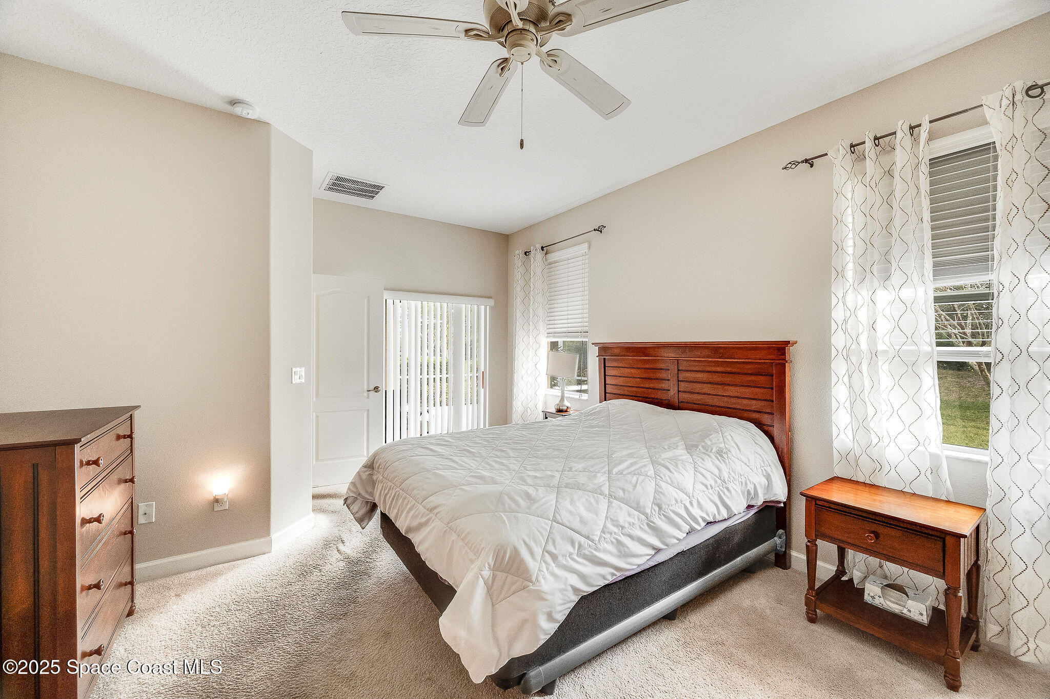6531 Ingalls Street Melbourne, FL 32940 - Photo 41 of 46 a bedroom with a bed and a ceiling fan