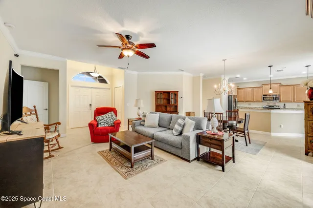 a living room with furniture and a view of kitchen