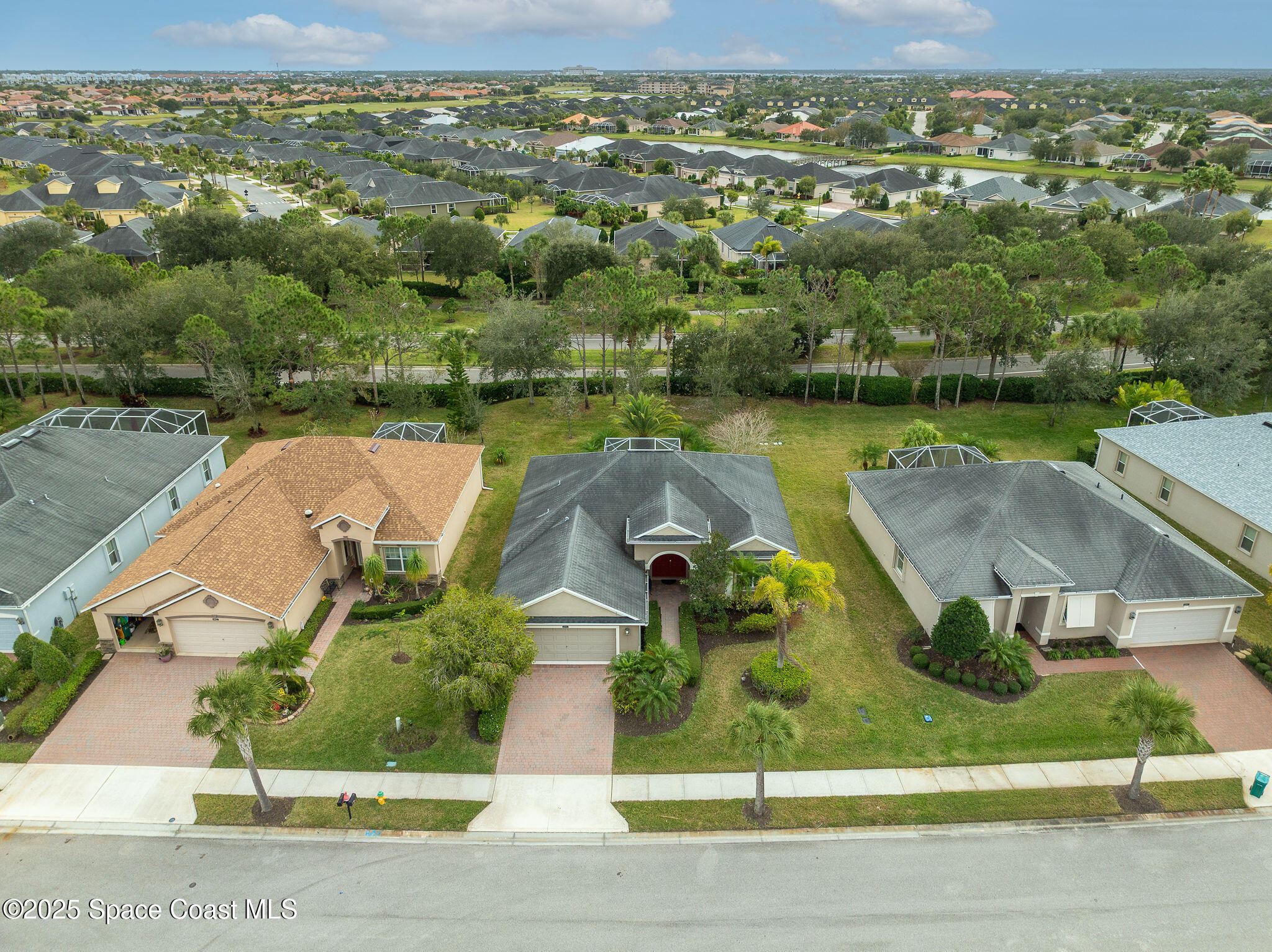 6531 Ingalls Street Melbourne, FL 32940 - Photo 8 of 46 an aerial view of a house with a garden and lake view