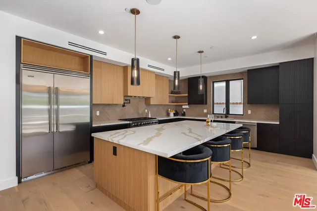 a kitchen with a stove a refrigerator and a sink