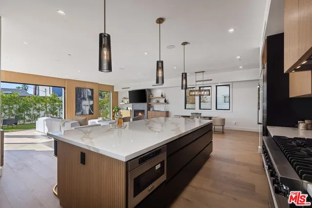 a kitchen with stainless steel appliances granite countertop a sink and a stove