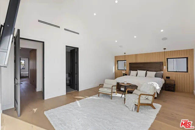 a spacious bedroom with a bed and a table