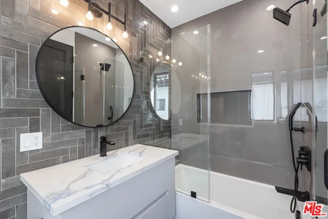a bathroom with a sink mirror and vanity